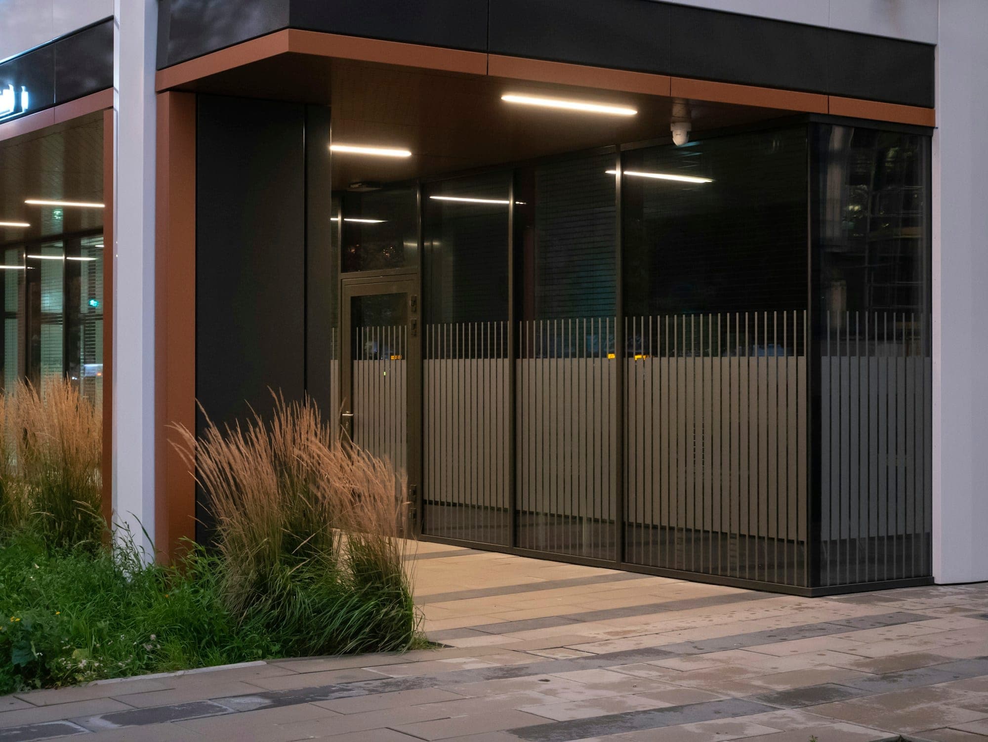 Building entrance with a dark aluminium and glass front